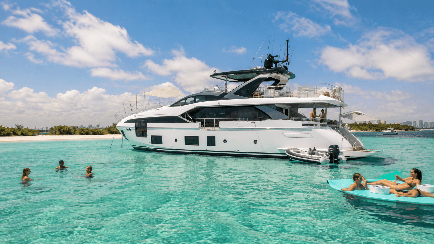White luxury yacht anchored in turquoise sea near sandy beach with people swimming 88 azimut 2023