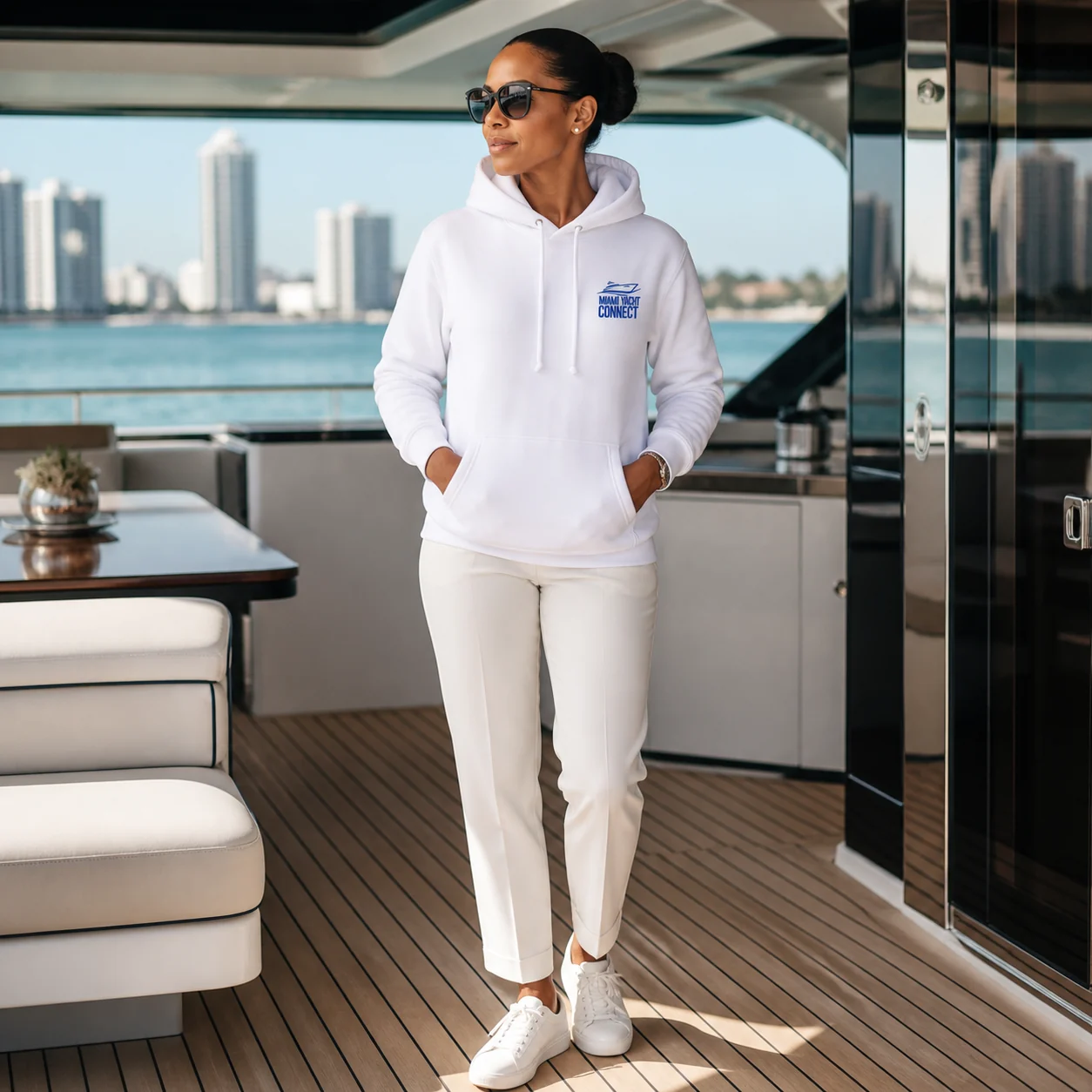 The white I'm The Captain Now hoodie worn on a yacht in Miami