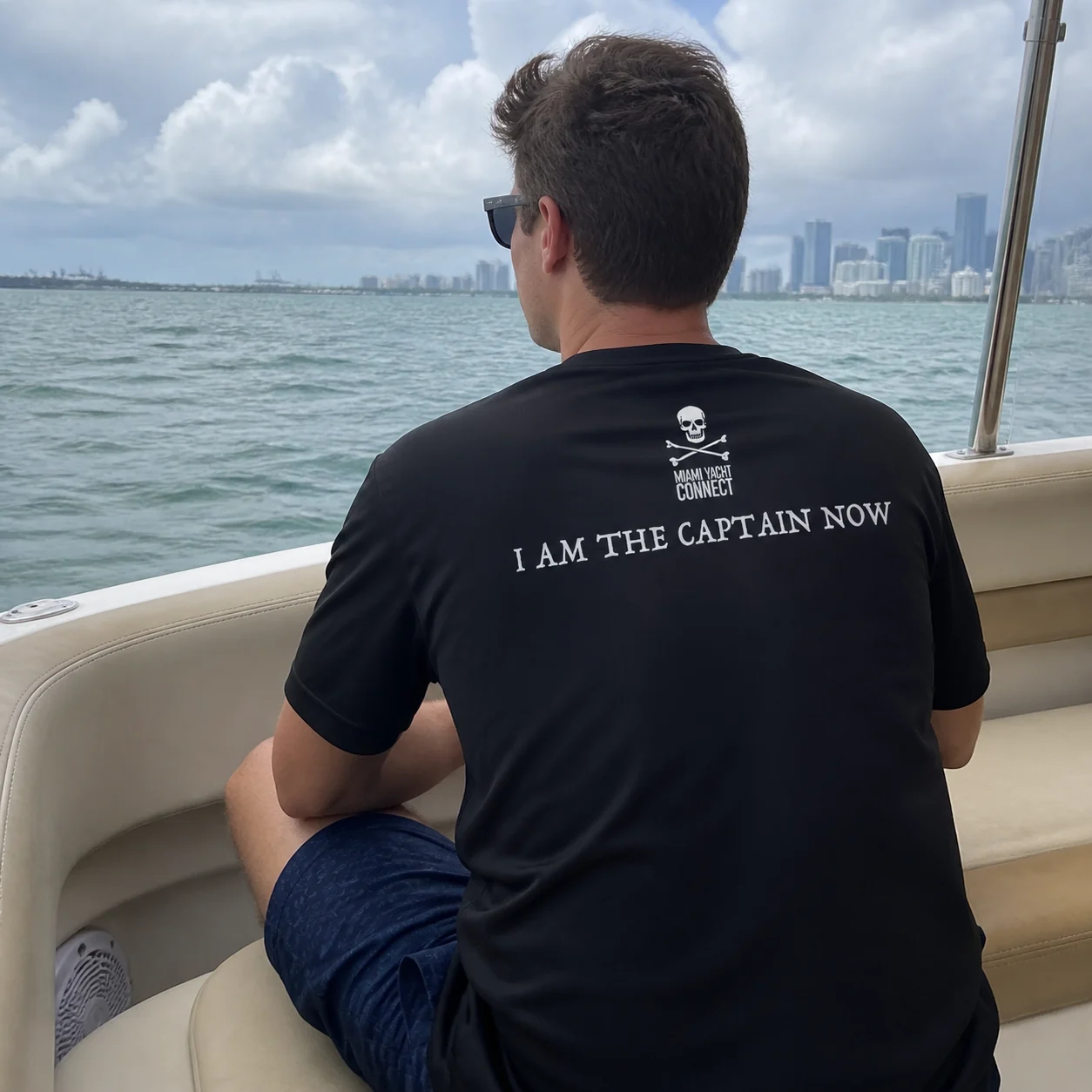 The black I'm The Captain Now t-shirt worn on a yacht in Miami
