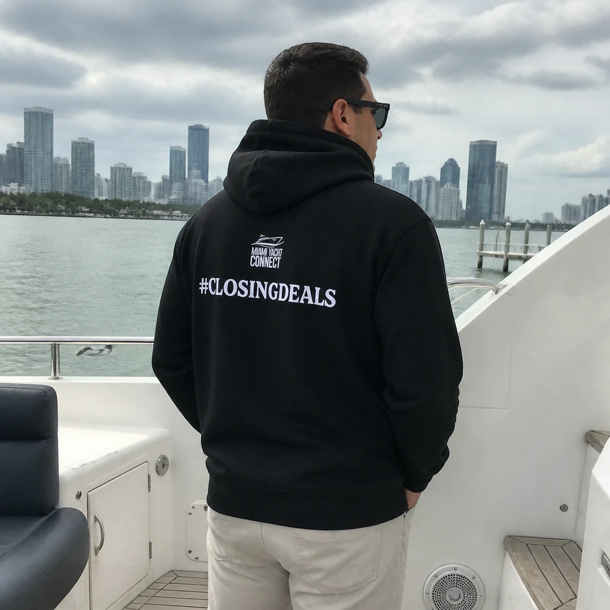 The black #ClosingDeals hoodie worn on a yacht in Miami