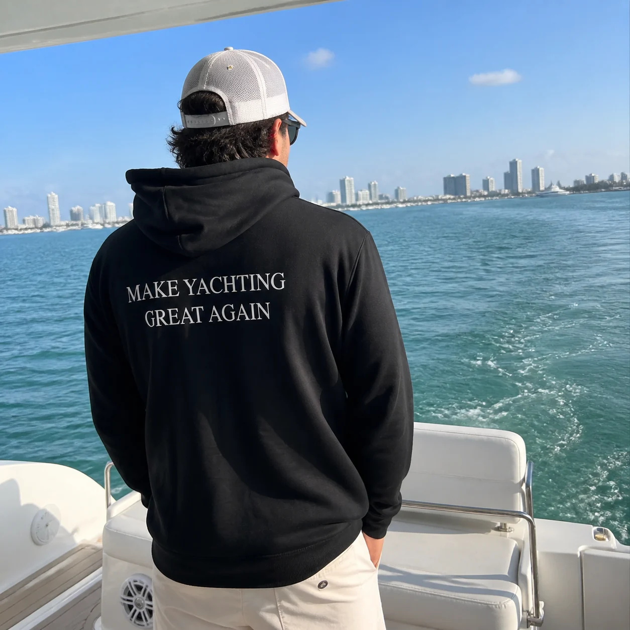 The black Make Yachting Great Again hoodie worn on a yacht in Miami