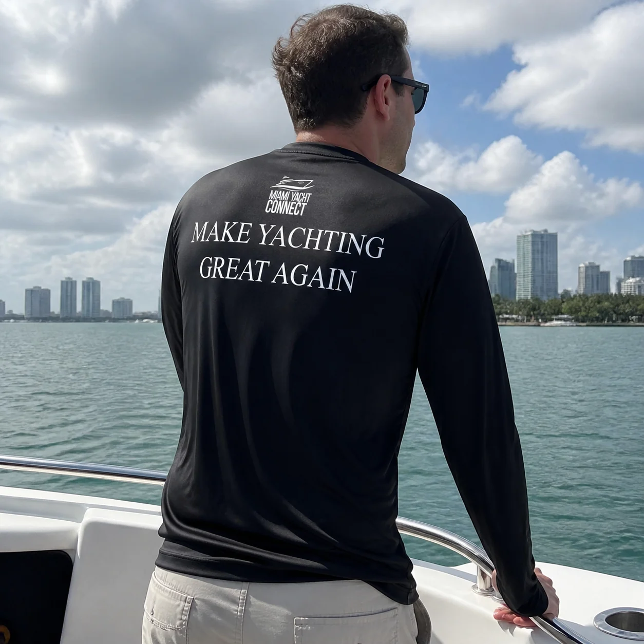 The black Make Yachting Great Again long-sleeve shirt worn on a yacht in Miami