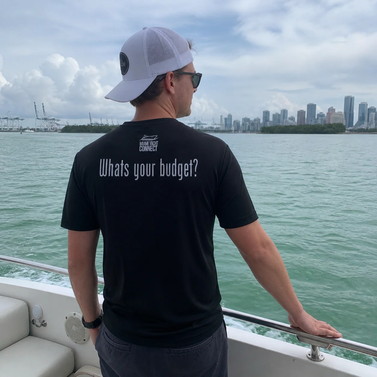 The black What's Your Budget t-shirt worn on a yacht in Miami
